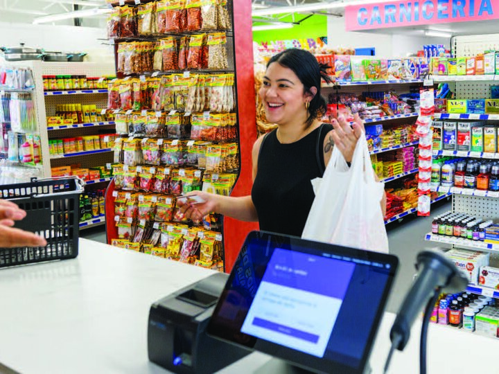 Young woman making a purchase at a grocery.