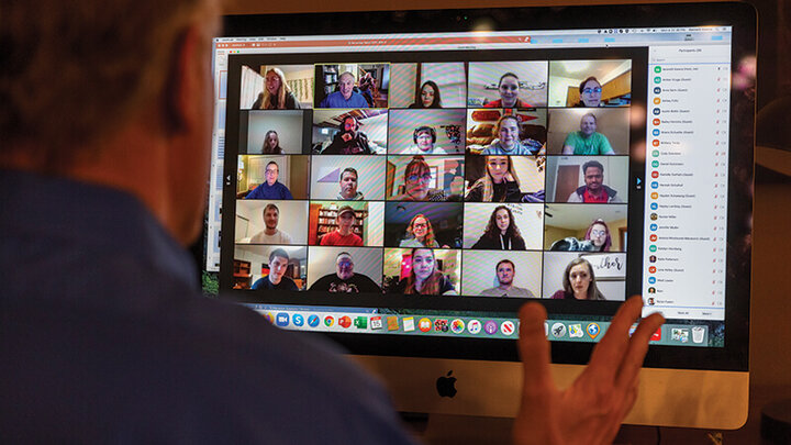 User looking at computer screen with Zoom meeting